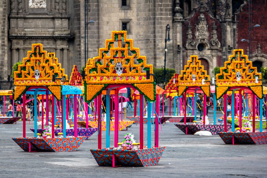 Colourful Day of the Dead (Día de los Muertos) altar decorations in a historic plaza in Mexico City.