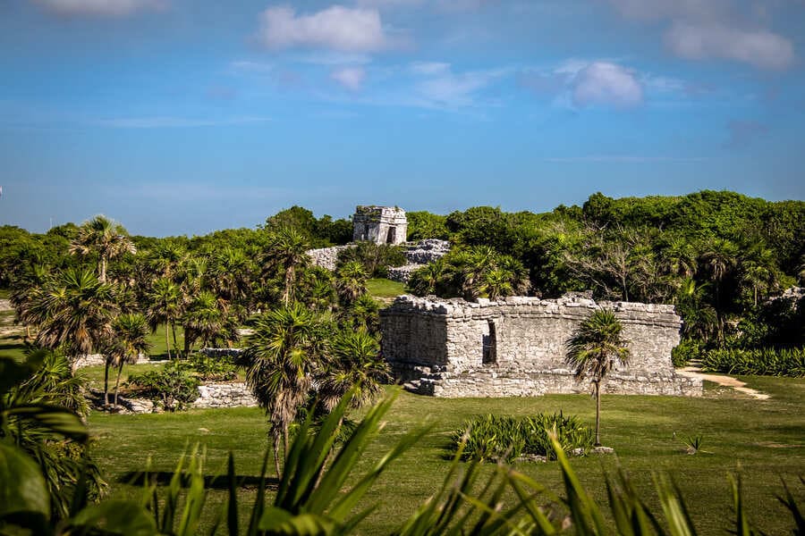 Ancient Mayan ruins surrounded by tropical vegetation at the Tulum archaeological site on Mexico’s Riviera Maya.